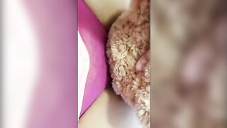 A girl is having fun with her teddy bear in a steamy way