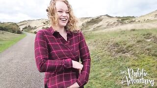 A happy and curvy girl plays with her dildo on the beach