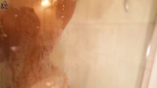 A little girl is having fun with a big dildo in the shower, getting wet