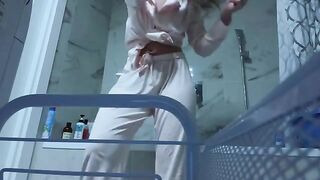 A petite girl wets her pussy in the bathroom, no one sees it