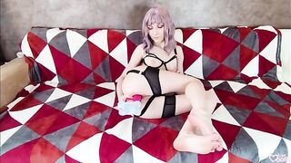 The girl, in sexy black underwear, plays with a dildo and makes cum