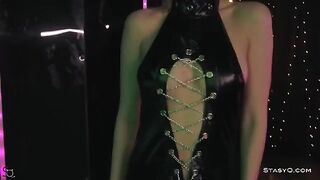 A skinny teen AngelQ in black lingerie is stripping on stage