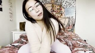 A happy Chinese girl plays with her pussy for the camera in an erotic scene