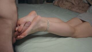 A small girl shows her feet and does a footjob