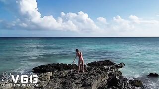 A petite and sexy girl is naked on the beach, enjoying the erotic atmosphere