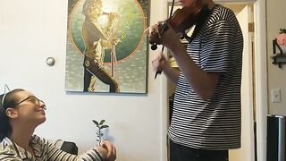 Girl trying to practice violin, but her boyfriend is jerking off