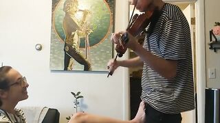 Girl trying to practice violin, but her boyfriend is jerking off