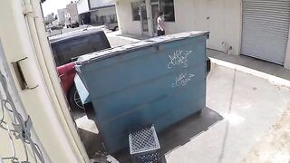 A couple got intimate behind the garbage tank, unaware of being captured