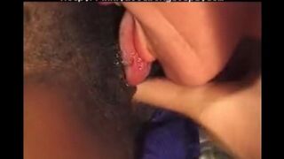 A young black woman has fun with an older white man on the bed