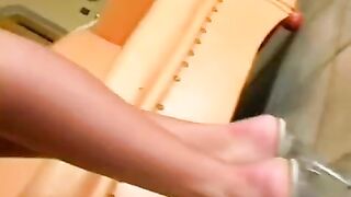 Nude beauty masturbating on a leather chair