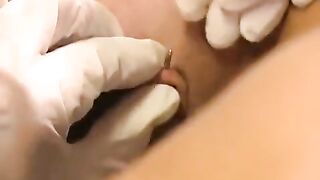 Girl plays with a new piercing in her clitoris