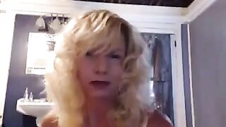 A mature woman caresses herself in the bathroom with pleasure