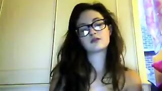 A cute student with glasses removes her clothes during a video call