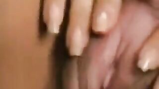 A girl with a big clitoris plays with her hairy pussy, showcasing her unique charm