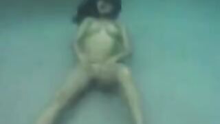 Busty brunette beauty has sex in the ocean, right in the water