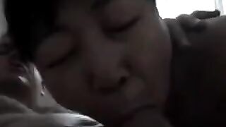 An old Chinese woman practices her blowjob skills on him