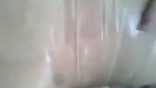 The guy put a condom on his dick and jerked it with his hand