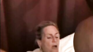 A beautiful mature woman is having sex with a black man