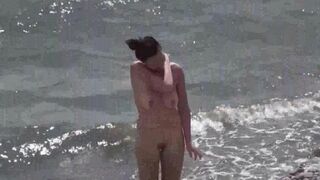A couple of free-spirited lovers enjoying a beach day without clothes
