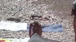 A couple of free-spirited lovers enjoying a beach day without clothes
