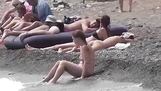 A couple of free-spirited lovers enjoying a beach day without clothes