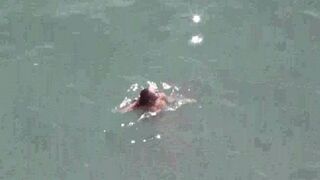 A pair of naked lovers enjoy each other at sea