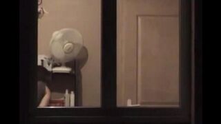 The guy admires himself in the mirror completely naked