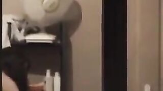 The guy admires himself in the mirror completely naked
