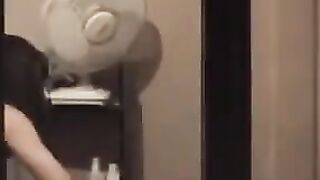 The guy admires himself in the mirror completely naked