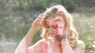 Blonde woman masturbates on the lake shore