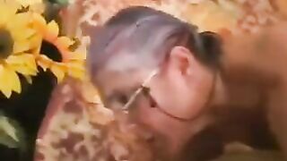 A mature gray-haired woman in black stockings gets fucked hard