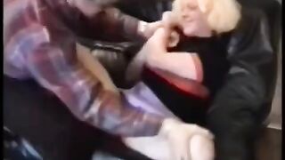 A pretty babe fucked by two motorcyclists on a couch in a rough session