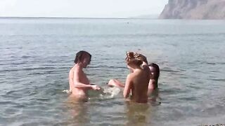 Nudist beauties are fucking on the sandy beach without any clothes