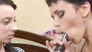 A mom is giving a lesson to her daughter on how to do a blowjob