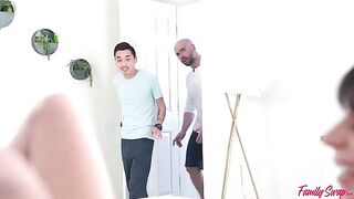 A girl is having fun with two guys at a party
