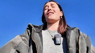 A hot brunette babe masturbates on the public beach